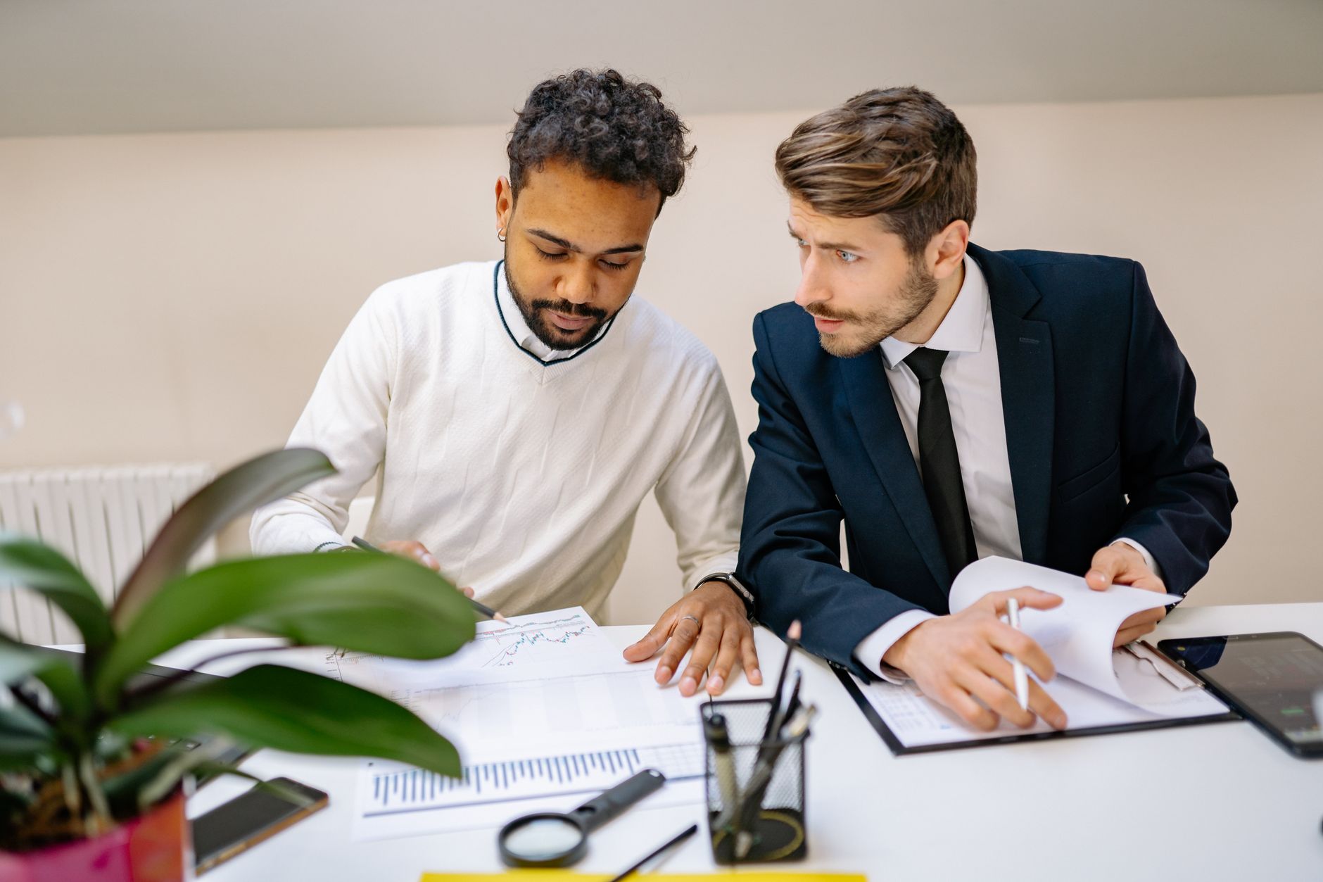 A broker and a risk manager working through an insurance application together at a desk